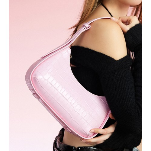 A pink silver bag with a design on one shoulder A pink silver bag with a design on one shoulder