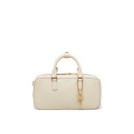 Leather tote bag worn crossbody over one shoulder